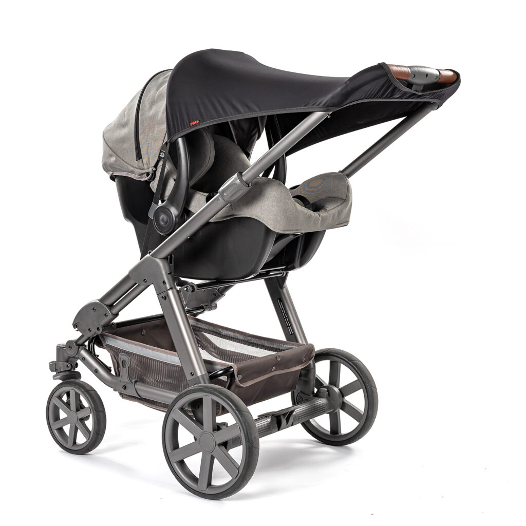 Reer ShineSafe black UPF 50+ universal suncover fitted on a pram to protect baby from direct sunlight